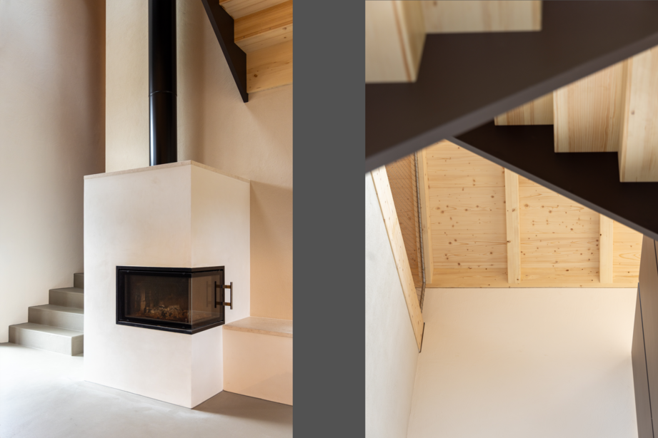 Wohnraum im Neubau einer Wohnscheune mit Speicherofen, offener Holzstruktur und moderner Treppenkonstruktion.